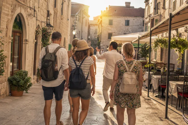 A small group of travellers on a guided walk through an old town