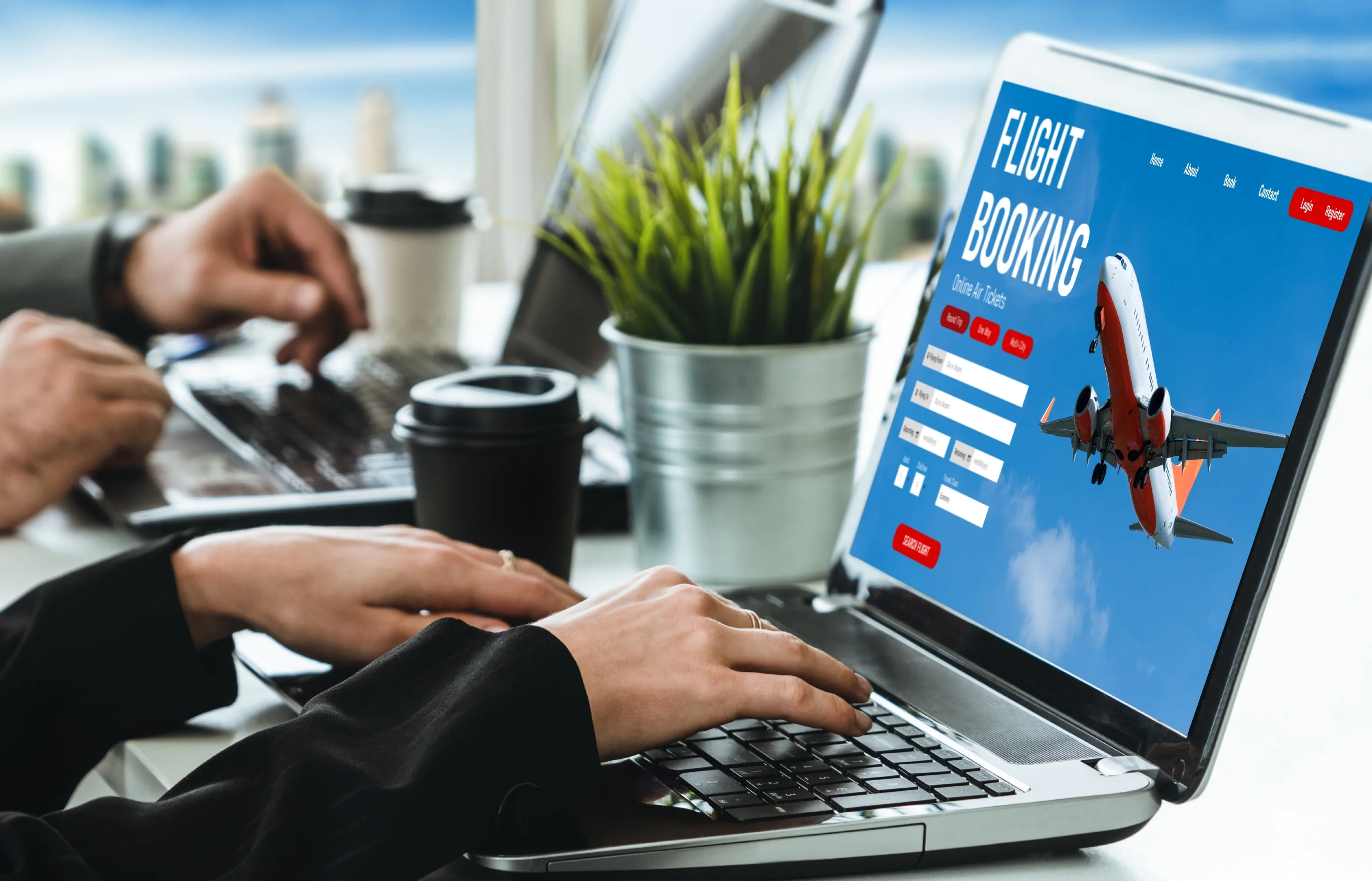 Travel professional using a laptop to search and book flights