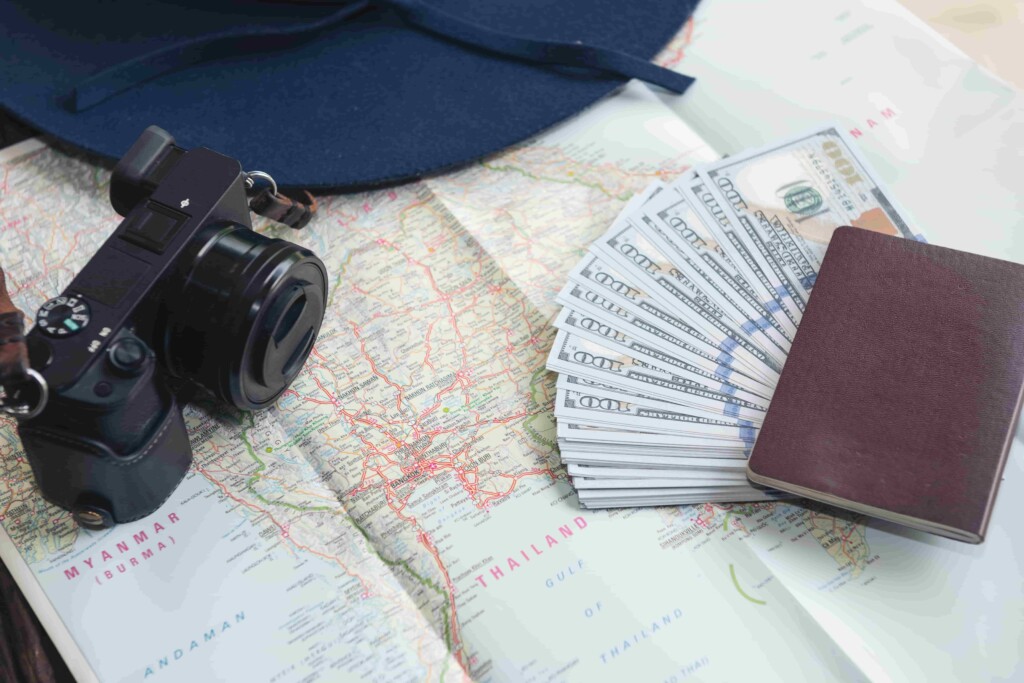 Multi currency travel payments with passport cash and map used for international travel expense management